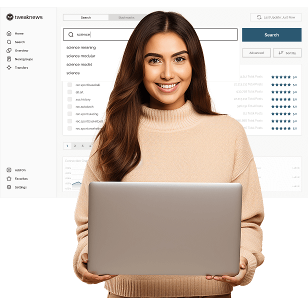 A woman in a beige, turtleneck sweater is smiling at the camera and holding a laptop in both hands.